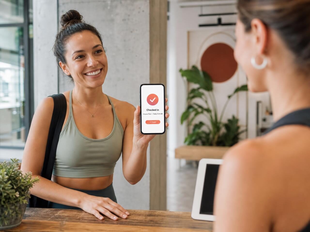 Student checking in at the front desk with a phone showing a checked-in confirmation and a point earned
